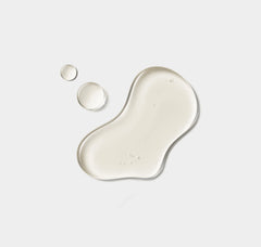 Beige liquid droplets on a light gray background