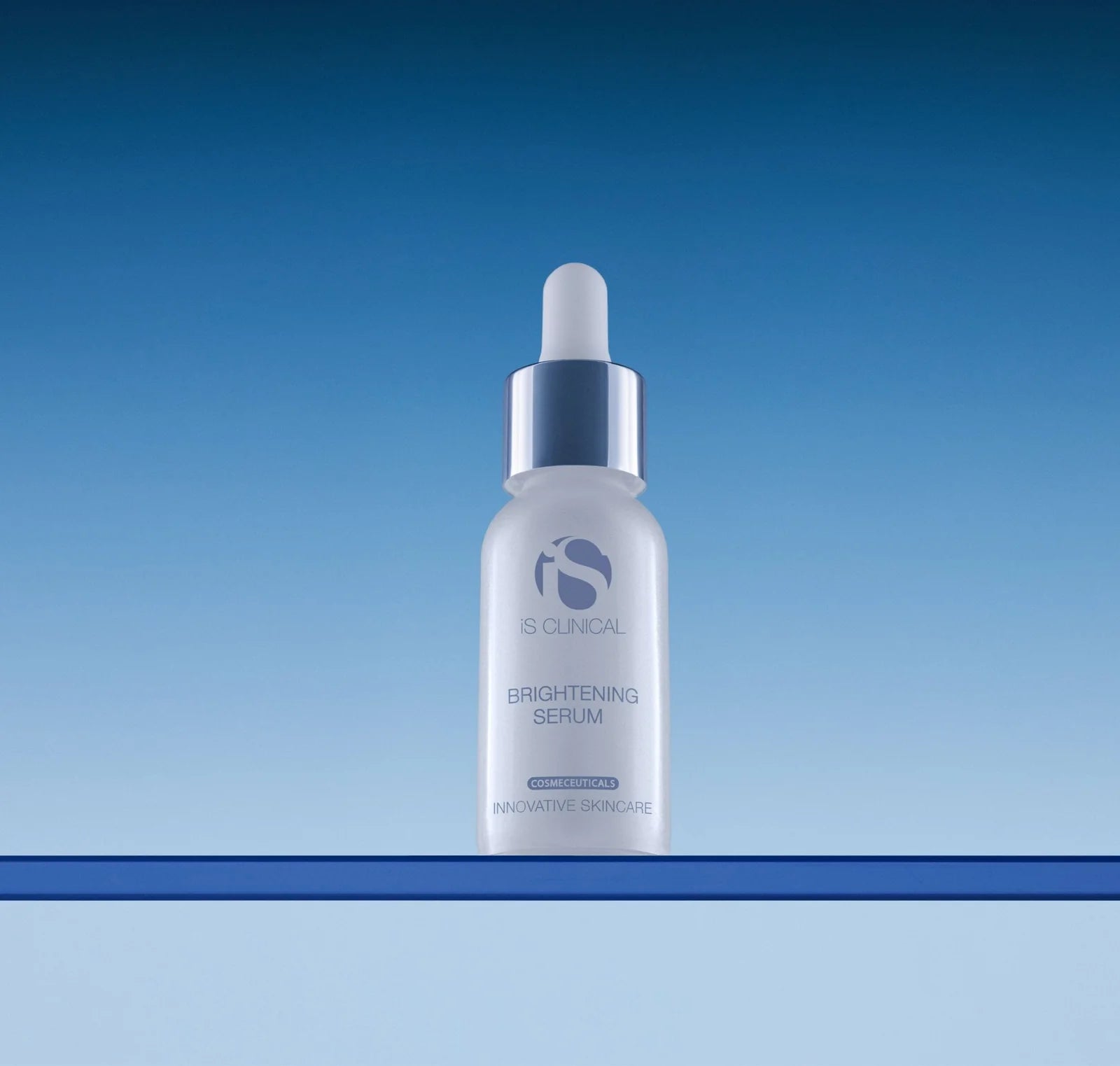 iS Clinical brightening serum bottle on a gradient blue background