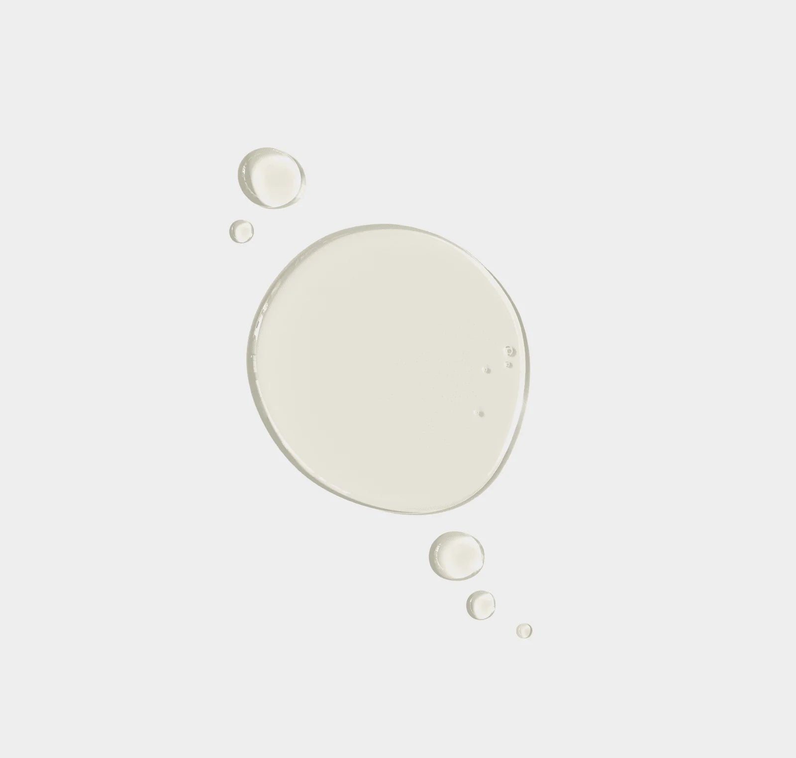 White liquid droplets on a light gray background
