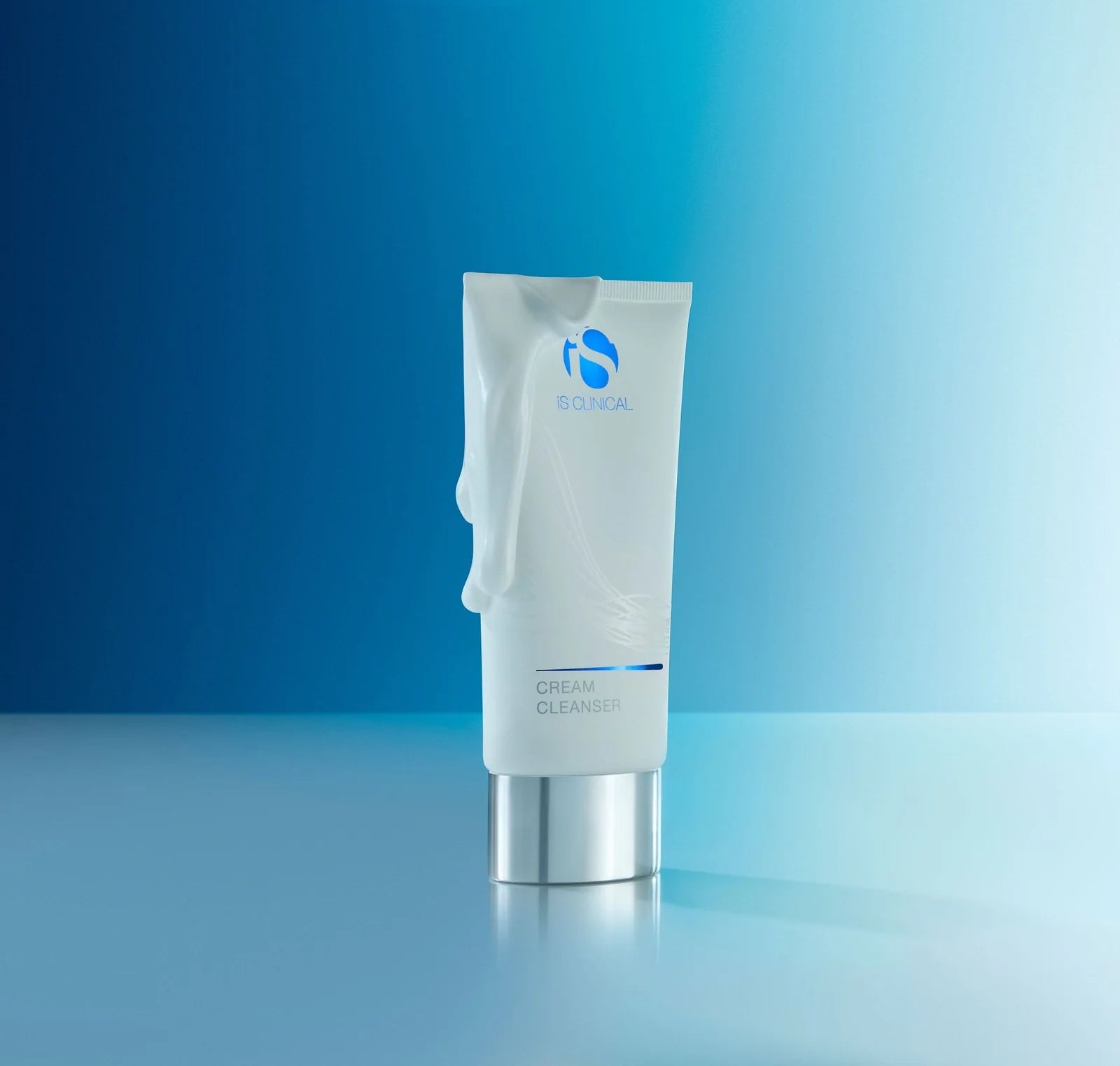 Tube of cream cleanser on a blue gradient background