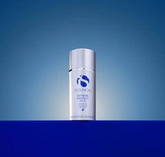 IS Clinical Extreme Protect SPF 40 skincare bottle on a blue gradient background