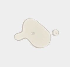 White paint droplet and swirl on a light gray background