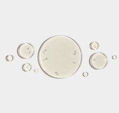 White circular droplets on a light gray background