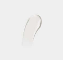 White cream smear on a light gray background