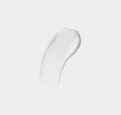 Close-up of a white cosmetic product on a light gray background