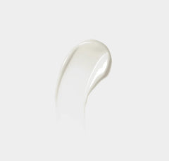 White cream or gel smear on a light gray background