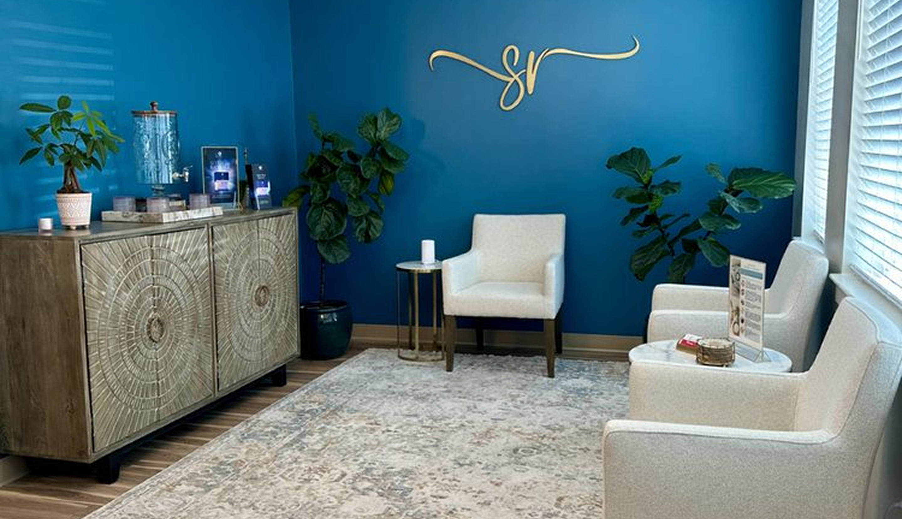 Living room with blue walls, beige furniture, and decorative elements.