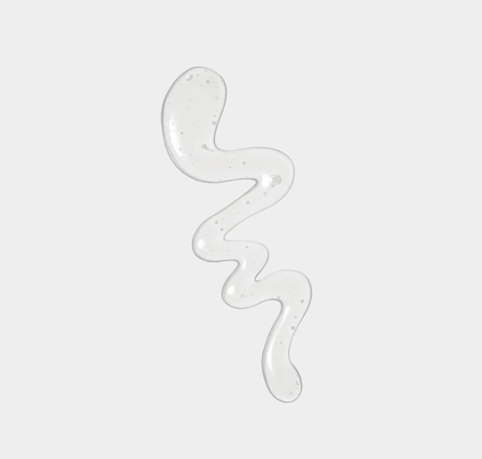 Transparent gel-like substance in a wavy pattern on a light gray background