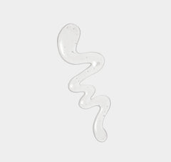 Transparent gel-like substance in a wavy pattern on a light gray background
