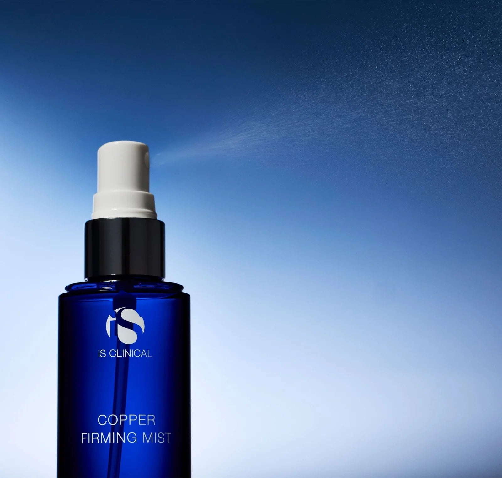 Blue spray bottle labeled 'IS CLINICAL' with a white mist against a blue gradient background