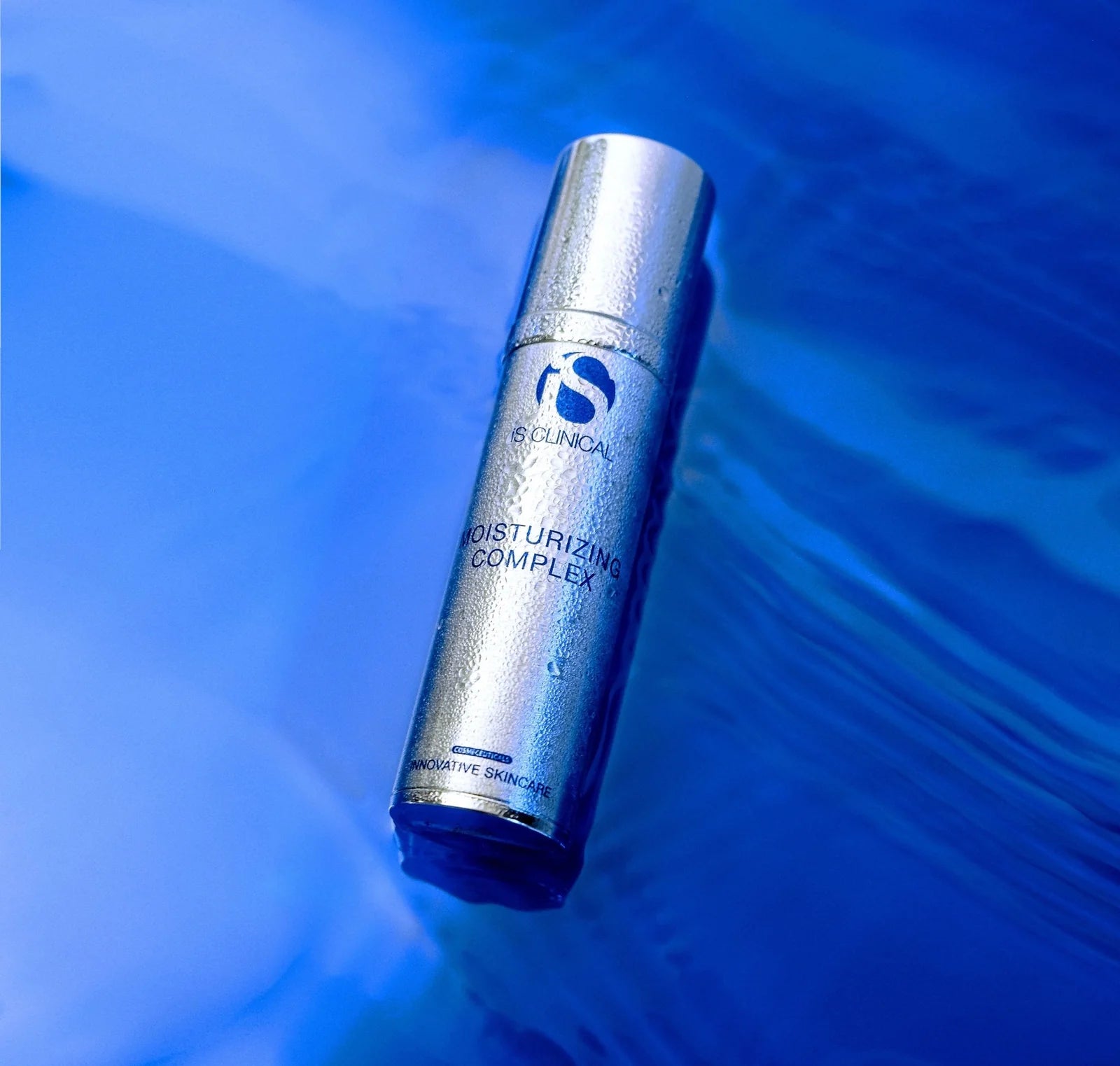 Skincare serum bottle labeled 'N. Clinical' on a blue water background