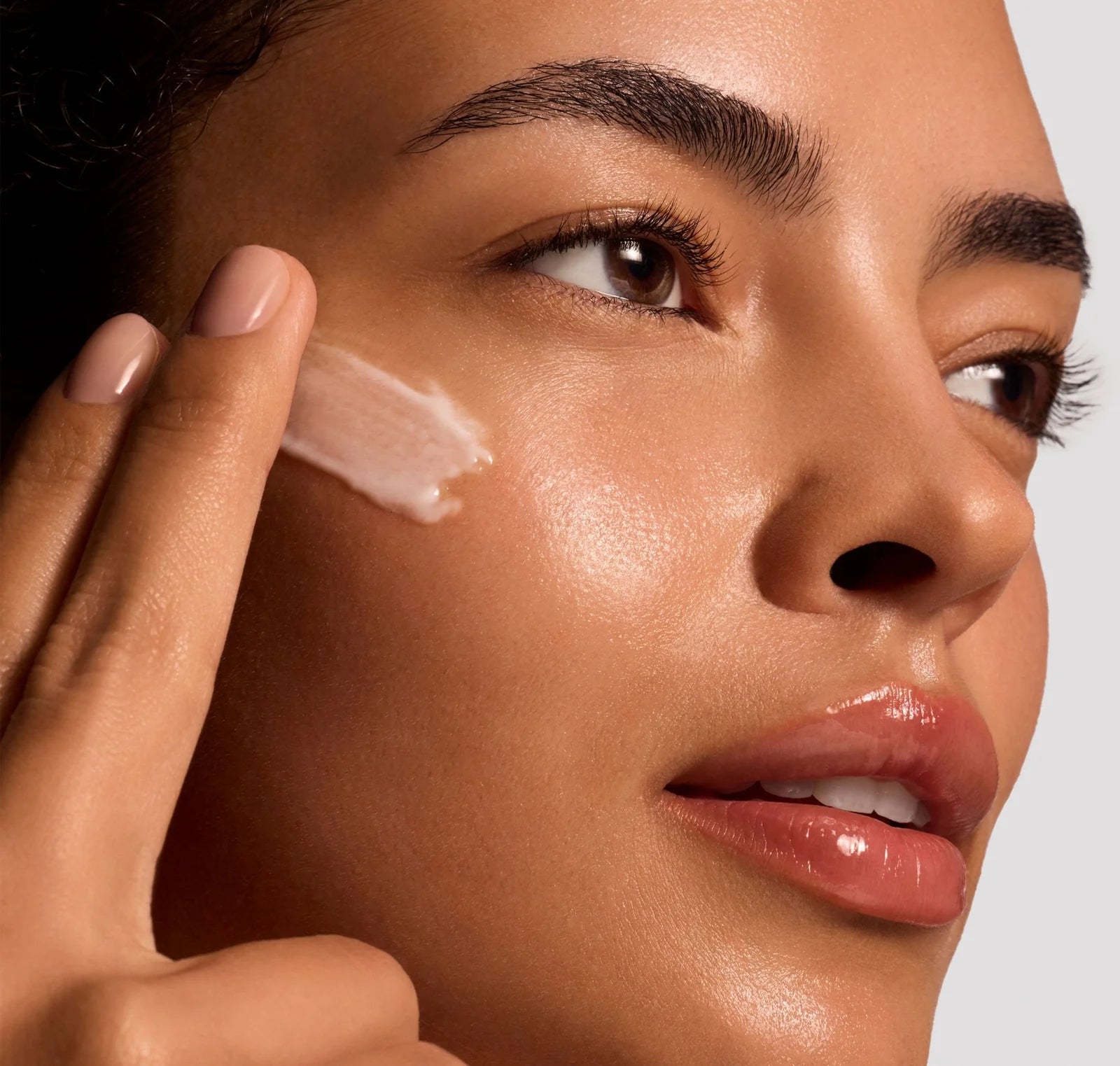 Woman applying a skincare product to her face