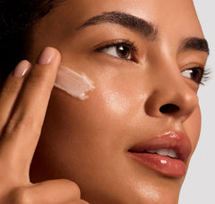 Woman applying a skincare product to her face