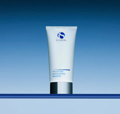 Tube of IS Clinical Tri-Active Exfoliating Masque on a blue gradient background
