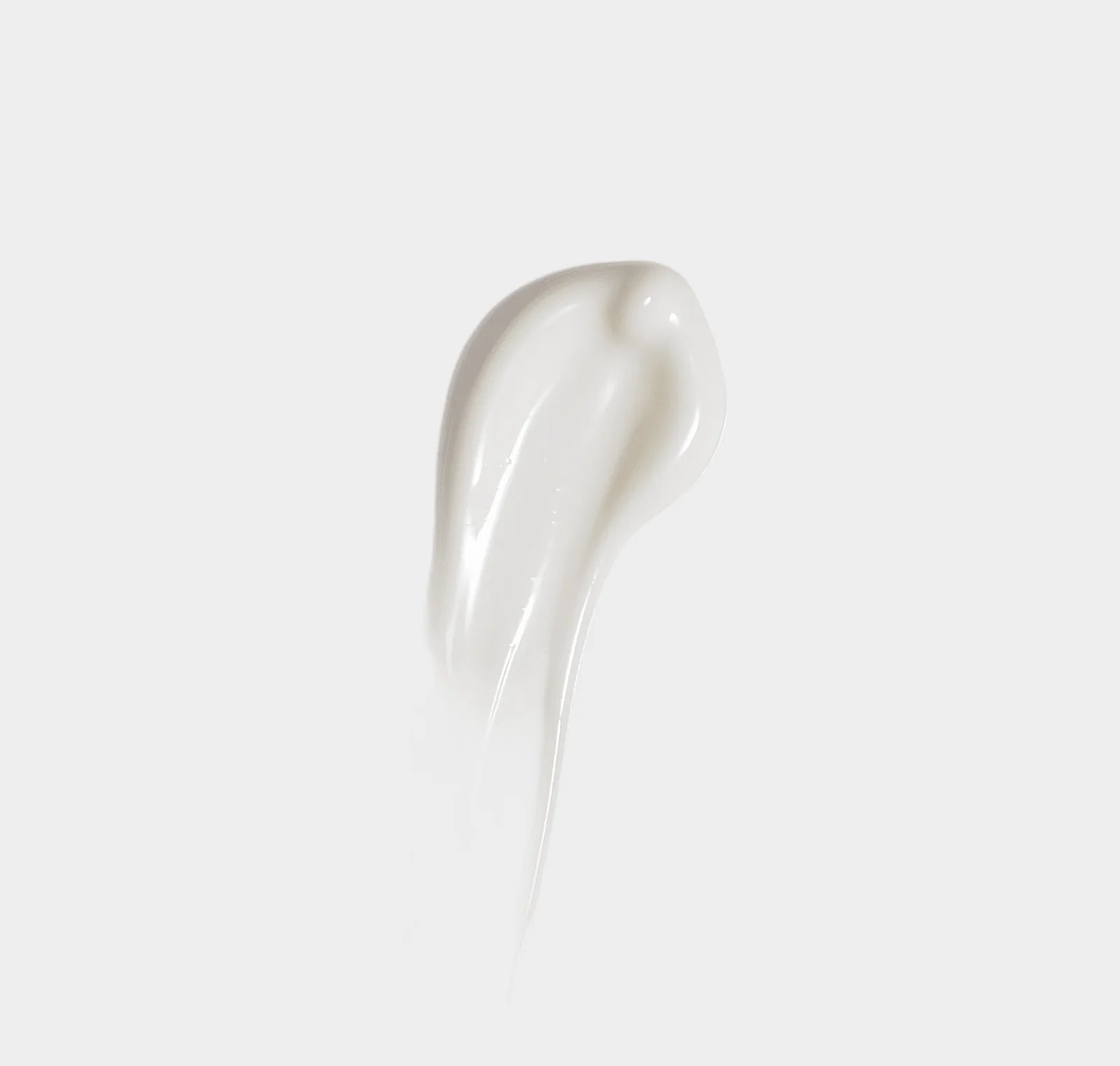 White ceramic spoon on a light gray background