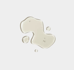 Beige liquid paint splashes on a light gray background
