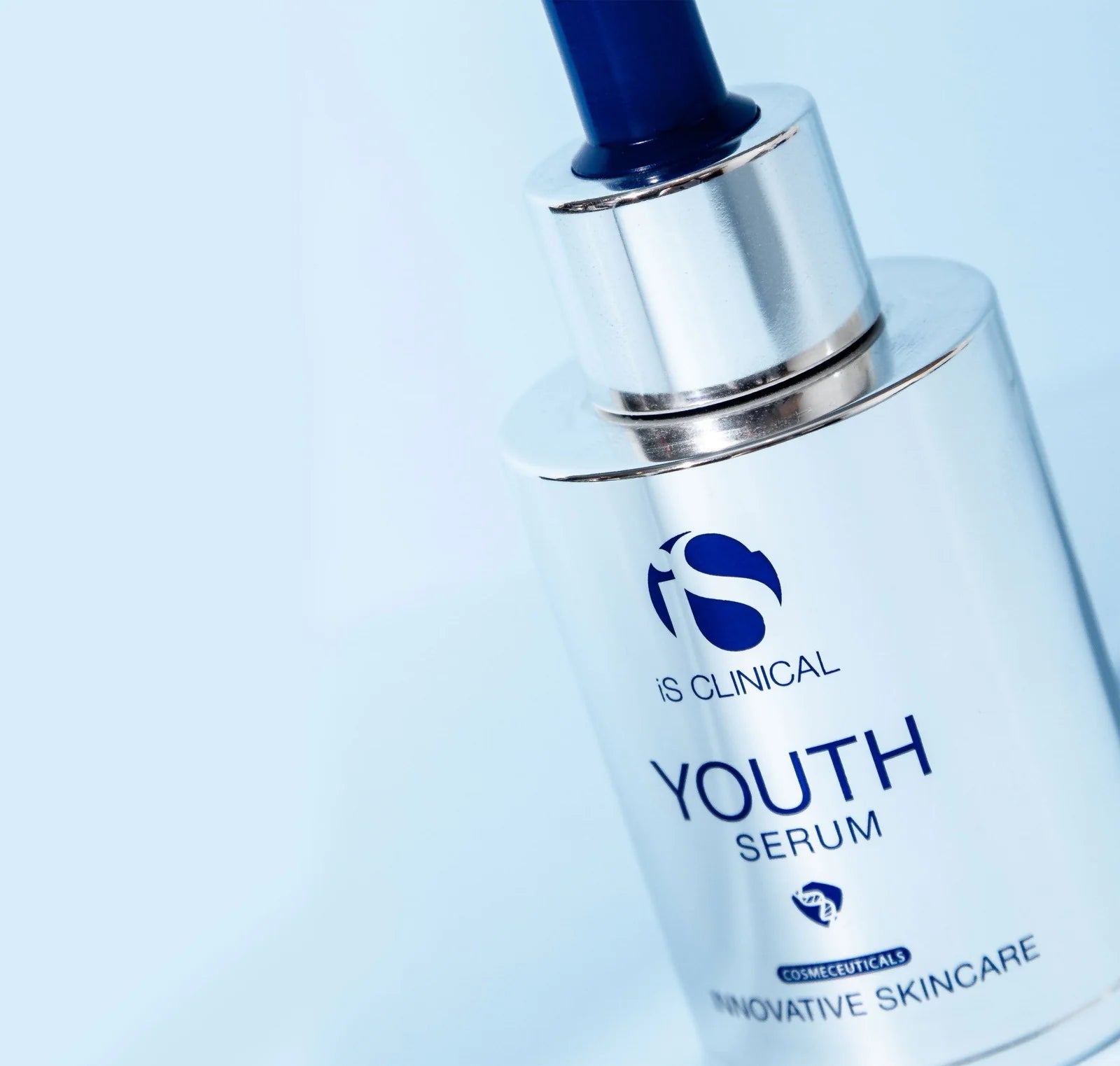IS Clinical Youth Serum bottle on a light blue background